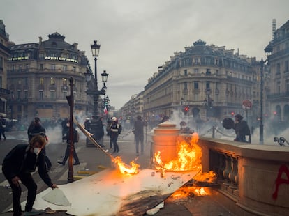 Varios manifestantes queman restos de basura mientras la policía lanza gases lacrimógenos frente a la Opera de París, el jueves.