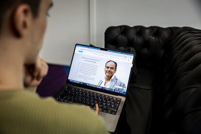 A man looks at the Immucura website, which features a picture of Johannes Schumacher, its founder and CEO.