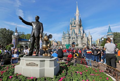 Statue of Walt Disney and Micky Mouse stands in front of the Cinderella Castle at the Magic Kingdom at Walt Disney World