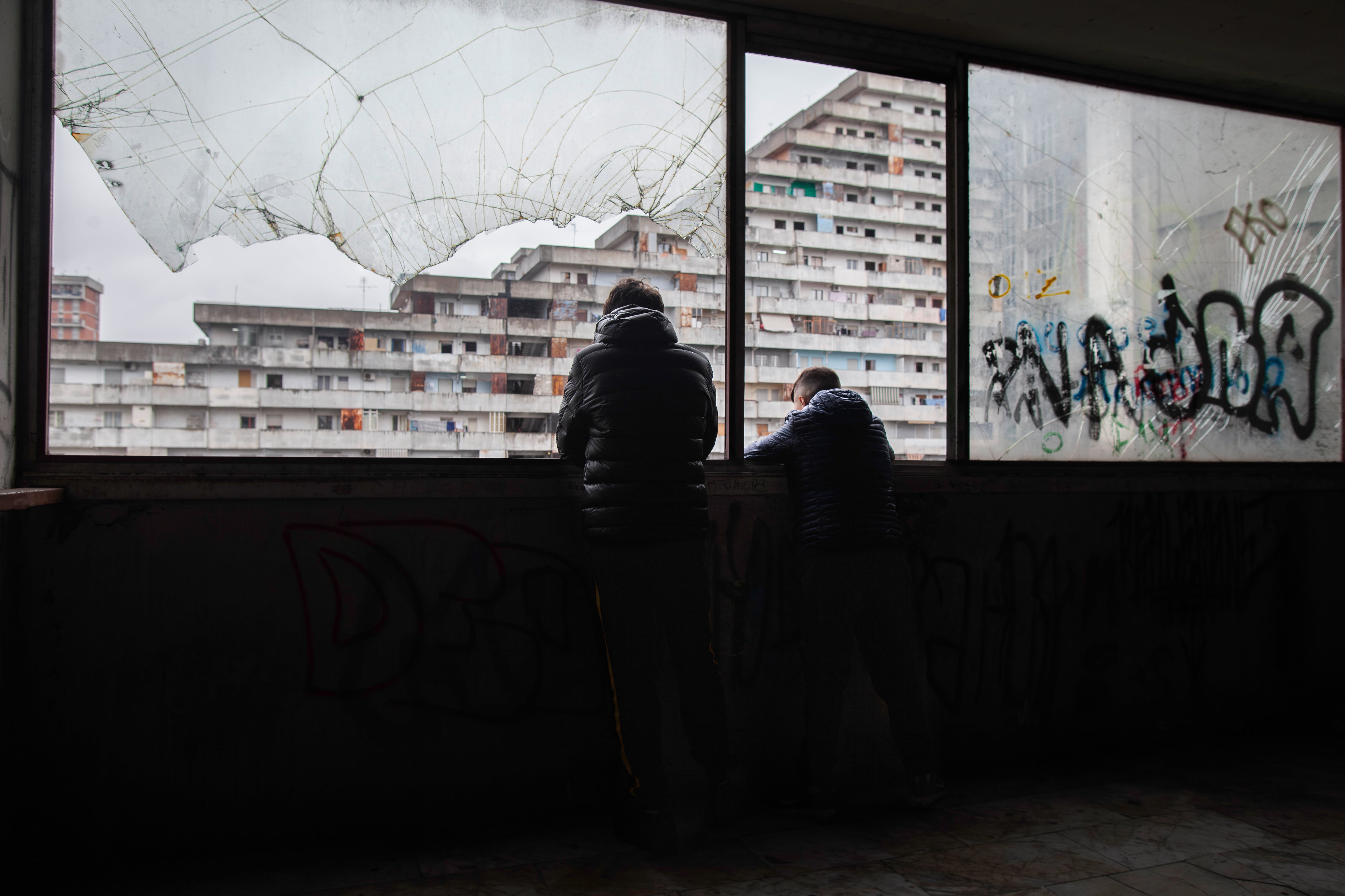 Dos adolescentes, asomados a una ventana del barrio de Scampia, en Nápoles.