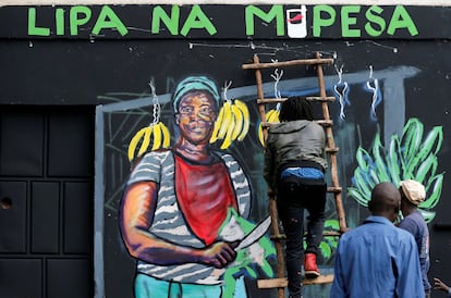 Un artista trabaja en un mural que aboga por los pagos sin dinero en efectivo de los teléfonos móviles M-Pesa como medida contra la propagación de la covid-19 en Nairobi, Kenya, el pasado 19 de abril.