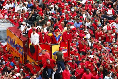 Supporters surround a truck carrying Venezuelan President Hugo Ch&aacute;vez as he makes his way to file his candidacy.