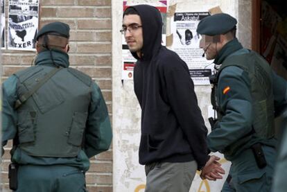 Iker Moreno, the son of Batasuna spokesman Txelui Moreno, is escorted away by civil guards.