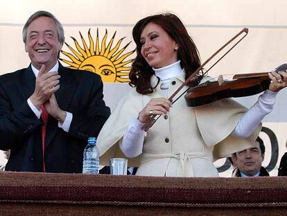 Néstor Kirchner aplaude mientras su esposa, Cristina Fernández, simula tocar un violín el jueves en un acto en Santiago del Estero (noroeste de Argentina).