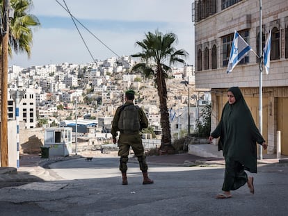 Una mujer palestina camina junto a un punto de seguridad israelí en Hebrón, Cisjordania, el 25 de noviembre de 2021.