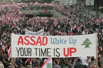 Manifestantes antisirios portan una pancarta en la que se lee "Asad, despierta, tu tiempo se ha acabado", en la marcha que ha recorrido hoy las calles de Beirut.