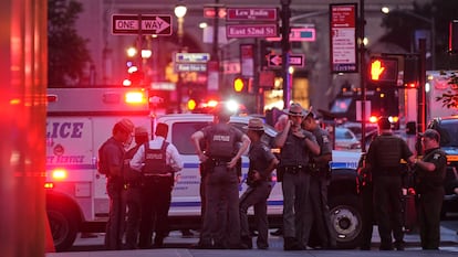 New York State Police troopers gather on 52nd Street outside a Manhattan office building where two people were shot, including a New York police officer, Monday, July 28, 2025, in New York. (AP Photo/Angelina Katsanis)