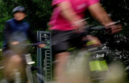 Cyclists are counted as they ride past the Rosslyn Bikeometer on National Bike to Work Day in Arlington, Va.