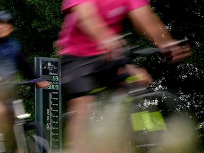 Cyclists are counted as they ride past the Rosslyn Bikeometer on National Bike to Work Day in Arlington, Va.