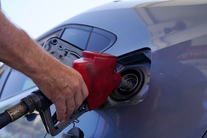 A customer pumps gas at an Exxon gas station, Tuesday, May 10, 2022, in Miami