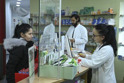 Una empleada atiende a una clienta en una farmacia de Berlín.