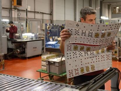 Un empleado de Naipes Fournier en Vitoria comprueba el corte de las cartas.