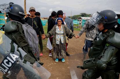 Habitantes se toman de las manos para evitar el desalojo.