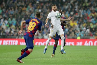 Karim Benzema controla la pelota ante Samuel Umtiti del FC Barcelona.