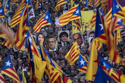 Manifestantes sustentam fotos dos políticos presos acompanhados de uma imagem de Puigdemont, líder catalão que optou pelo autoexílio na Bélgica.