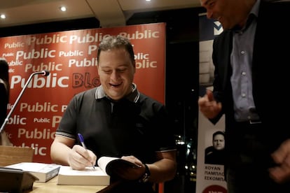 Pablo Escobar’s son signs a copy of his book about his father.