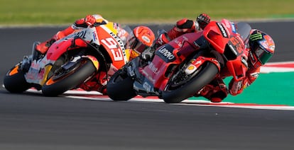 Italian rider Francesco Bagnaia of the Ducati Lenovo Team steers his motorcycle followed by Spain's rider Marc Marquez of the Repsol Honda Team during the MotoGP race of the Emilia Romagna Motorcycle Grand Prix at the Misano circuit in Misano Adriatico, Italy, Sunday, Oct. 24, 2021. (AP Photo/Antonio Calanni)