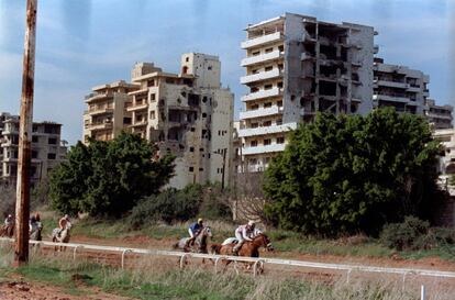 Jockeys compete during a horse race at Beirut Hippodrome, Lebanon, in 1992. REUTERS/Jamal Saidi  SEARCH "SAIDI HIPPODROME" FOR THIS STORY. SEARCH "WIDER IMAGE" FOR ALL STORIES.
