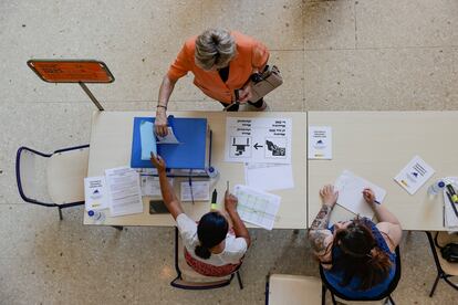 Una mujer deposita su voto en un colegio electoral del barrio de la Malvarrosa de Valencia, este noche.