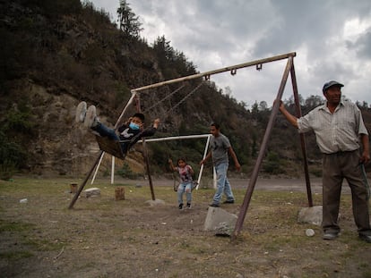 Francisco Castro juega con sus hijos en la ladera del volcán Popocatépetl en Xalitzintla, Puebla.