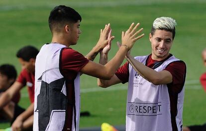 Nasri saluda a su compañero Correa en el entrenamiento del Sevilla.