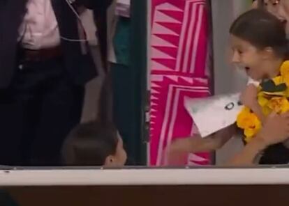 Una niña recibe una playera de una jugadora de futbol.