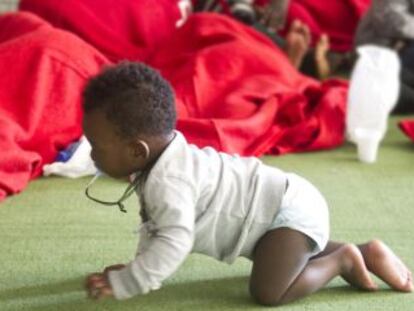 A baby crawls on the floor of a former sports center turned into an immigrant shelter in Tarifa last August.