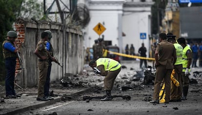 Security officers inspect the area where a bomb exploded in Colombo.