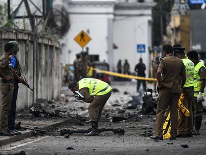 Security officers inspect the area where a bomb exploded in Colombo.