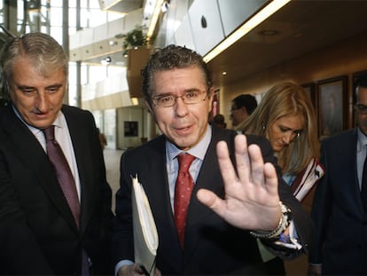 El consejero Francisco Granados (con una carpeta de documentos bajo el brazo) llega ayer a la Asamblea de Madrid para dar explicaciones sobre la presunta trama de espionaje.