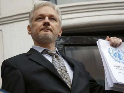 Julian Assange segura um relatório da ONU na embaixada de Equador.