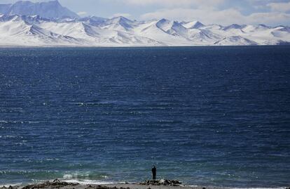 A Tibetan man stands at shores of Namtso lake in the Tibet Autonomous Region, China November 18, 2015. Located four hours' drive from Lhasa at an altitude of around 4,718m (15,479 ft) above sea level, Namtso lake is not only the highest saltwater lake in the world but also considered sacred, attracting throngs of devotees and pilgrims.