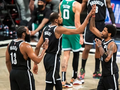 Brooklyn Nets guard James Harden (13), forward Kevin Durant (7) and guard Kyrie Irving celebrate during the first half of Game 1 of an NBA basketball first-round playoff series Saturday, May 22, 2021, in New York.