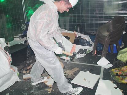 A young man enters a room to smash things.