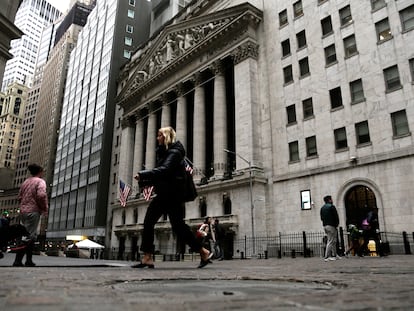People pass the front of the New York Stock Exchange in New York, on March 22, 2023.