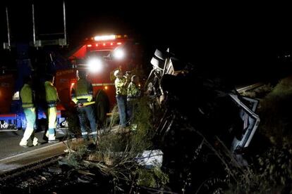 Civil Guard officers examine the overturned vehicle.