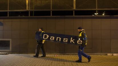 Dos operarios se llevan el cartel de Danske Bank en la filial de Tallin (Estonia), el 5 de octubre de 2019.