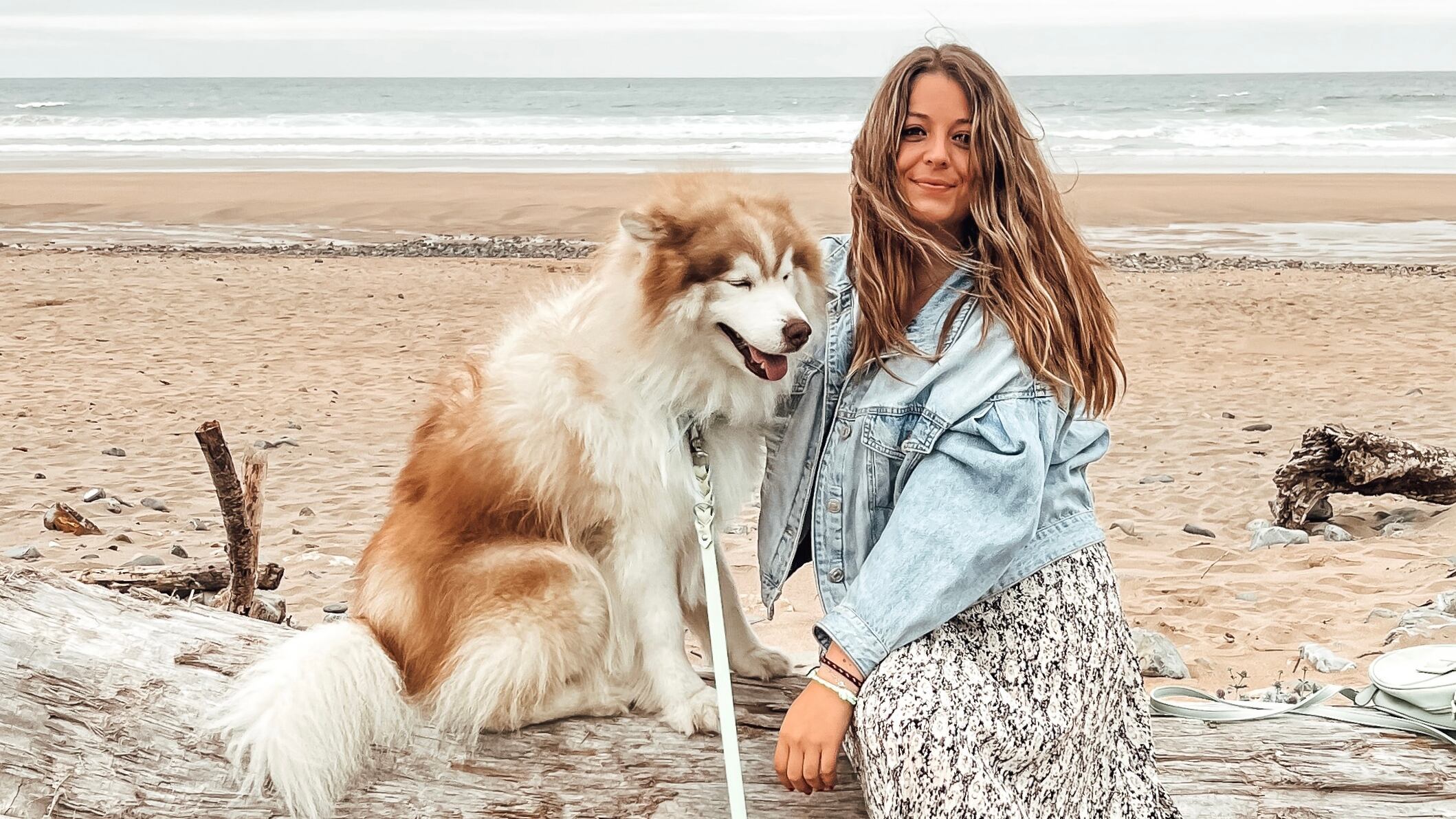 Patricia Fernández, creadora de contenido, y su perro 'Brus', en la playa de Vega (Asturias), en una imagen cedida. 