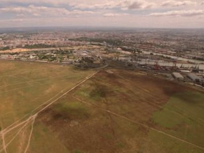 Vista a&eacute;rea de los terrenos de Tablada con Sevilla al fondo. 