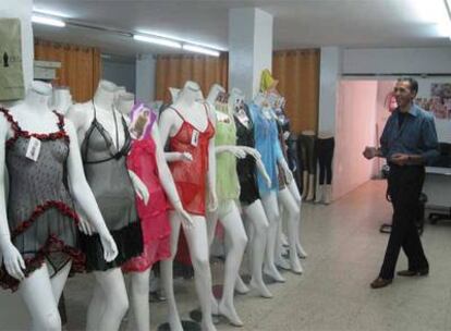 Hamed Shawar, con los modelos de enaguas y camisones importados de China que exhibe en su tienda.