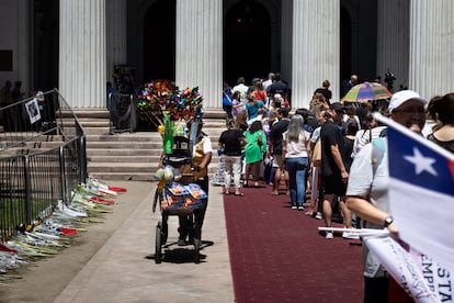 Un organillero camina junto a los asistentes al velorio de Piñera, a las puertas del exCongreso.