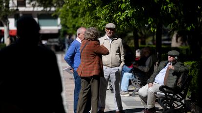 Personas mayores conversando en un parque en Sevilla.