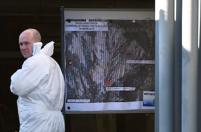 Un polic&iacute;a ante un mapa topogr&aacute;fico del lugar del siniestro de Germanwings. 