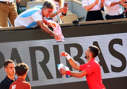 Djokovic recoge la camiseta de un aficionado en la Chatrier.