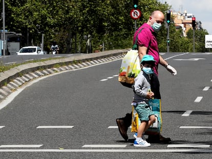 Un niño acompañado de un adulto por el centro de Madrid, este sábado.
