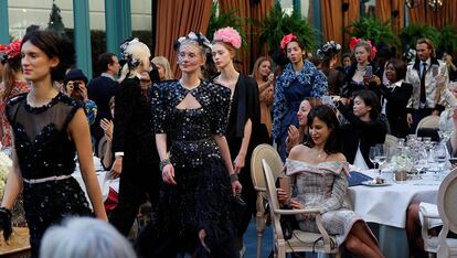 Models present creations with a Paris Cosmopolite theme by designer Karl Lagerfeld during the Metiers D&#8217;Art Show for Chanel fashion house in Paris