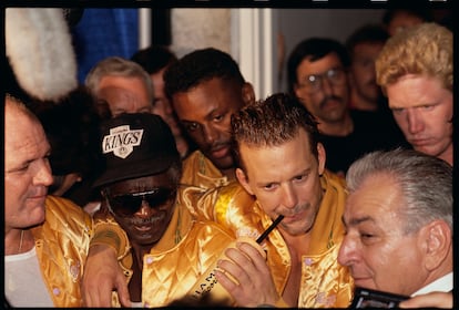 Mickey Rourke speaks to the press after participating in a boxing match in the 1990s.