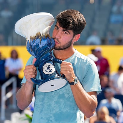 Aug 18, 2025; Cincinnati, OH, USA;  Carlos Alcaraz (ESP) poses for a photo with the Rookwood Cup after his match against Jannik Sinner (ITA) during the Cincinnati Open at the Lindner Family Tennis Center. Mandatory Credit: Aaron Doster-Imagn Images