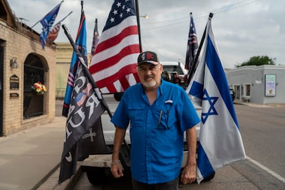 Roel Reyes stands in front of his flag-draped pickup truck in Rio Grande City, Texas, on Friday, Nov. 8, 2024. Reyes is the leader of the Starr County Trump Train, which consists of caravans of vehicles waving flags in support of the former president.