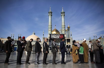 Iraníes esperan en fila antes de ejercer su voto en el santuario Massoumeh de la ciudad de Qom.